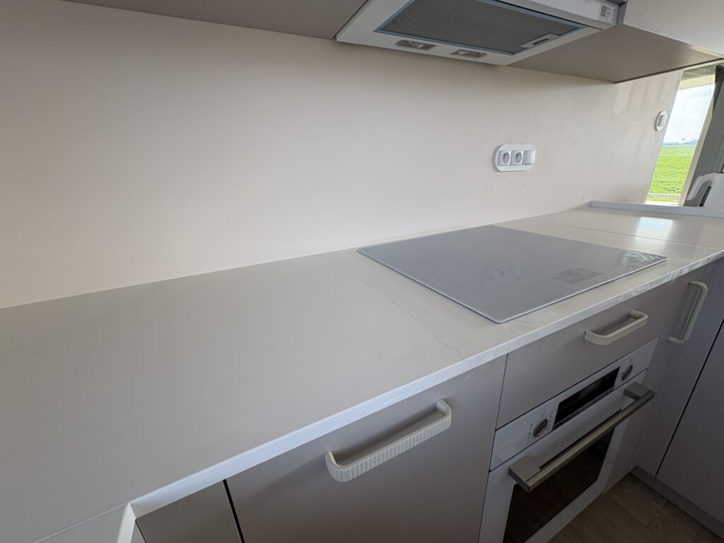 blaty kuchenne - konglomerat Calacatta Cannes Gold - widok na blat z płytą indukcyjną